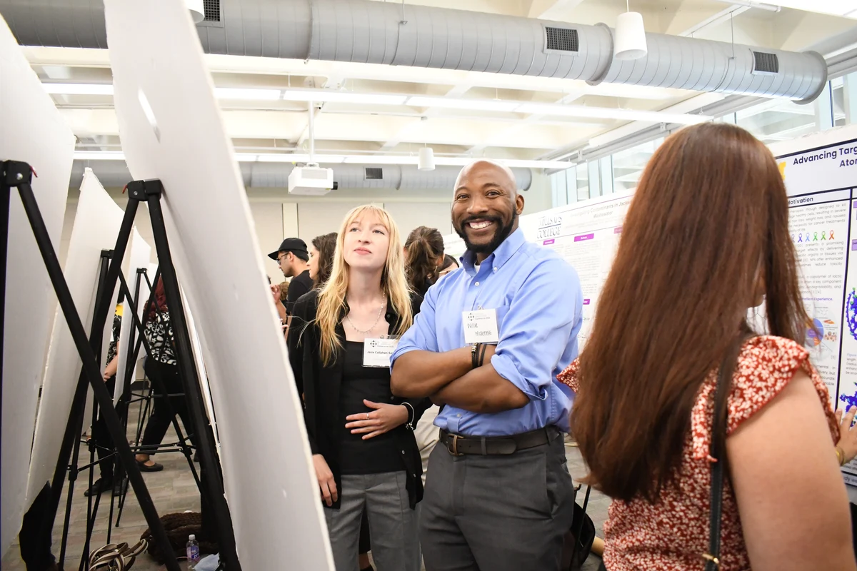 Researchers discussing work during a professional poster session