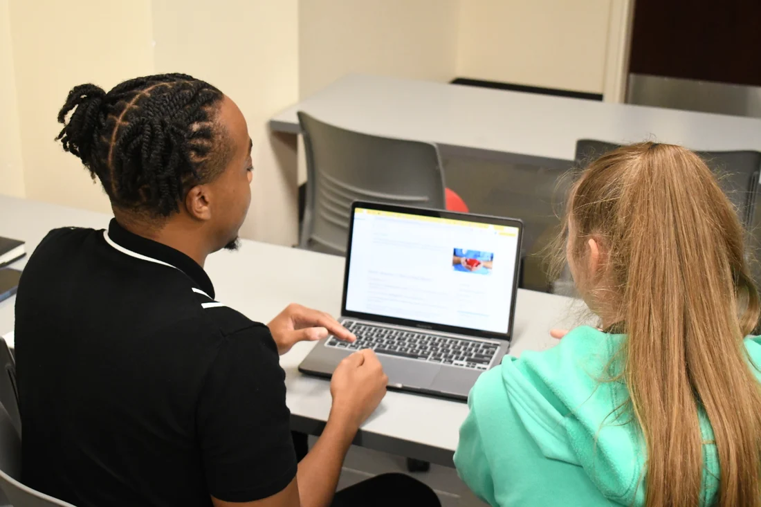 Researchers exchanging ideas and reviewing work at a professional conference