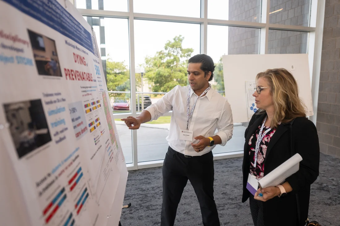A researcher discussing findings during a professional poster presentation